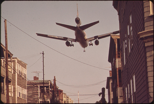 plane flies in low over houses to logan airport 1973